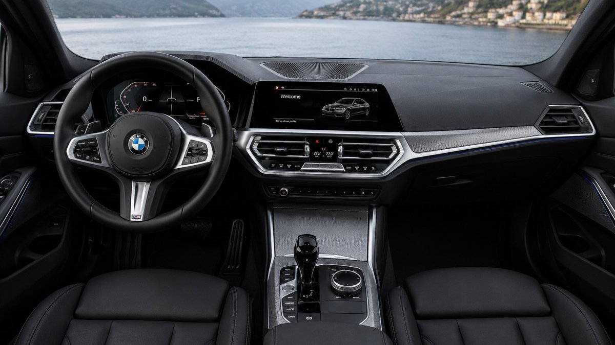 BMW 330i G20 interior showing the driver-focused cockpit and iDrive display